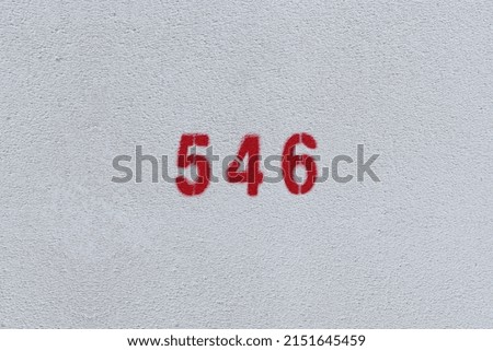 RED Number 546 on the white wall. Spray paint.
