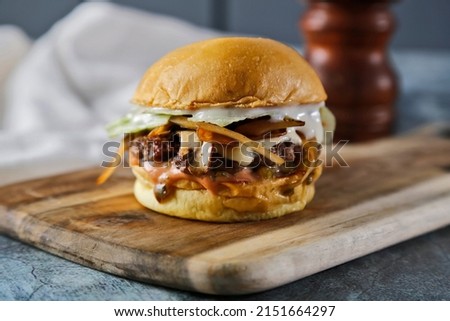 Beef burger with mushroom sauce and white cheese 