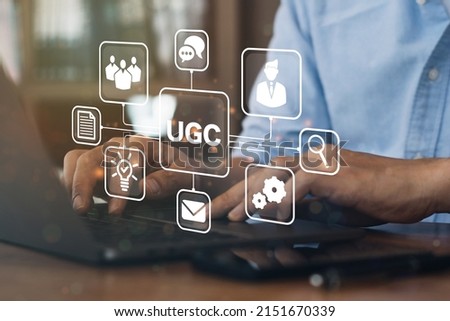 Businessman using a computer to "UGC" abbreviation and icon on laptop computer. User-generated content concept.(UGC) Online marketing concept. Customer create content on social media. Royalty-Free Stock Photo #2151670339