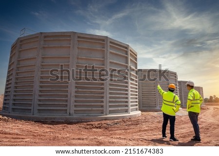 Teamwork of Civil and engineer plan the construction of unfinished concrete pipes for water treatment and wastewater treatment.They work at construction site of industrial estate. Utilities. Royalty-Free Stock Photo #2151674383