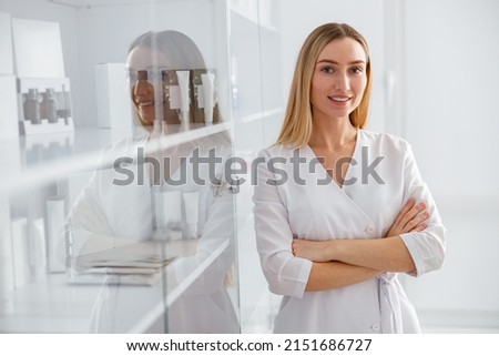 Cheerful female beautician standing in beauty salon Royalty-Free Stock Photo #2151686727