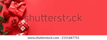 Presents for Valentine's Day and flowers on red background with space for text