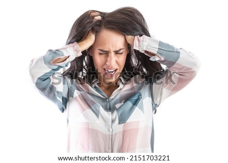 A woman under great stress holds her head with both hands. Isolated on white.