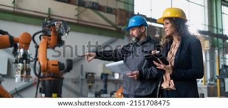 Female engineering manager and mechanic worker doing routine check up in industrial factory Royalty-Free Stock Photo #2151708475