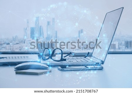 Close up of laptop on office desktop with city view and creative digital linear sphere on blurry background. Global network and communication concept. Double exposure