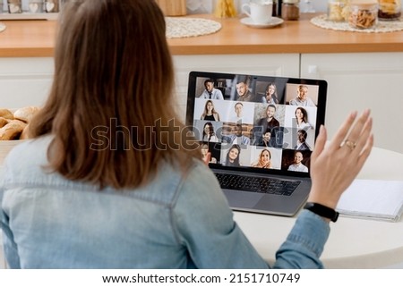 The concept of online video communication. Overlooking on the laptop screen with different people, employees, business partners, guy welcomes colleagues, online briefing, brainstorming, group remote. Royalty-Free Stock Photo #2151710749
