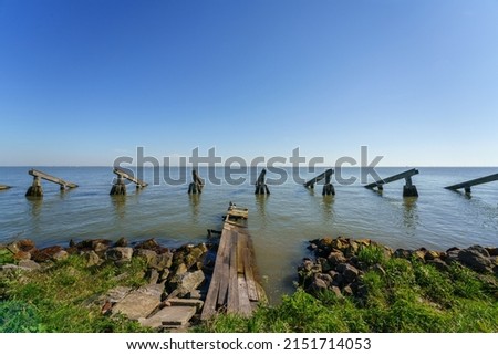 Seaside scenery and wooden stakes Royalty-Free Stock Photo #2151714053