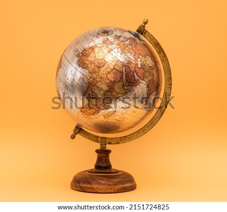 Old Style World Globe - Antique globe isolated on orange background. Showing Africa, Europe and part of Middle East.