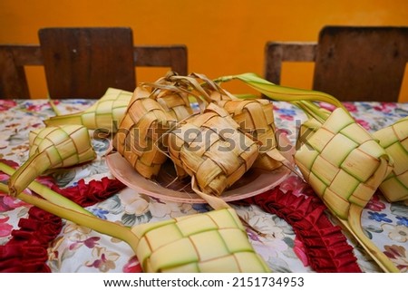 Ketupat, a special dish served at the celebration of Eid al-Fitr. Ketupat is a food made from rice that is packaged in a ketupat-shaped container from a woven bag of young coconut leaves.