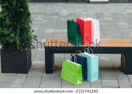 Colorful paper shopping bags on the street. shopaholic person at shopping mall