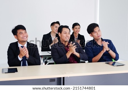 Smiling Asian businesspeople are clapping and having a seminar in the economics class in meeting room. Collegians are learning business and marketing class in university. Royalty-Free Stock Photo #2151744801