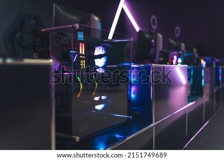 View from the back on colorful top-end system unit for gaming. Internet gamer cafe interior. High quality photo