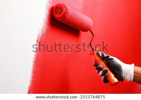 Painter is painting the interior wall red Royalty-Free Stock Photo #2151764875