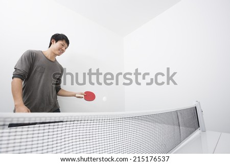Asian mid adult man playing ping-pong