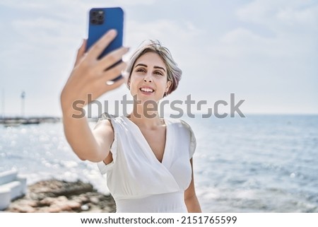 Young caucasian girl smiling happy making selfie by the smartphone at the beach.