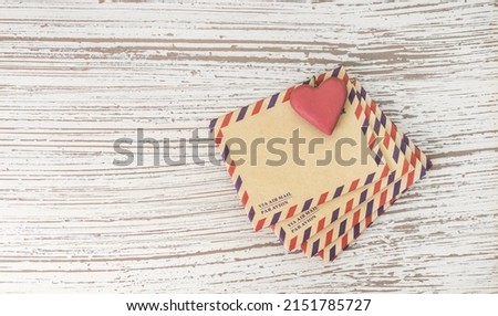 Stack of old envelope with shape of love retro heart