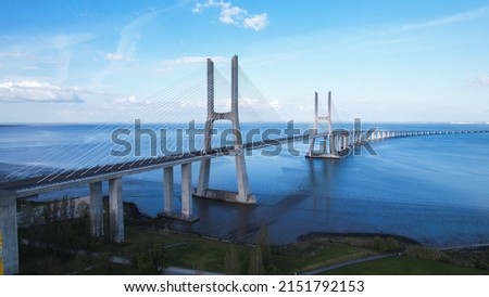 Aerial view of the Vasco da Gama Bridge is a cable-stayed bridge located in the city of Lisbon in Portugal and crosses the Tagus River. It is the second-longest bridge in Europe. Royalty-Free Stock Photo #2151792153
