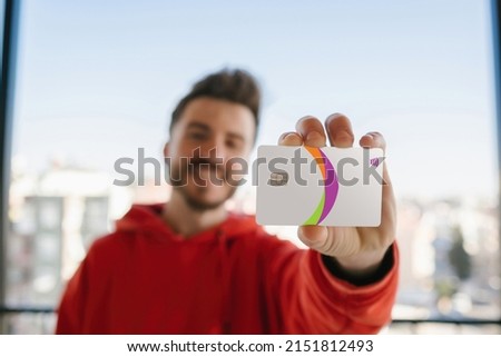 Credit card, young man showing front of credit card to camera, happy smile and safe internet shopping