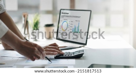 Businessmen use a calculator to calculate company financial statements for their colleagues, view and jointly solve problems within the company. Business finance and accounting concepts
 Royalty-Free Stock Photo #2151817513