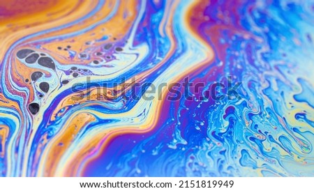 Macro photo of the texture of a soap bubble. Multicolored stripes. Psychedelic patterns