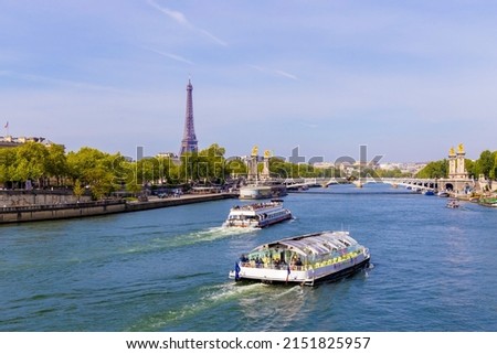 Tourist Boat On Seine River In Paris Europe With Eiffel Tower In Background.