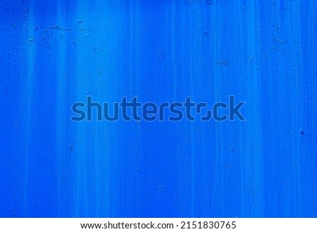 Deep blue metallic background. Painted metal wall. Blue paint streaks. Abstract blue background.