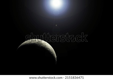Young Moon illuminated by the rays of the sun, with lens flare effect (photomontage).