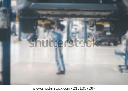 Blurred no focus background of car mechanic are checking cars. B