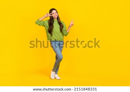 Full length photo of young cheerful girl show fingers peace cool v-symbol isolated over yellow color background