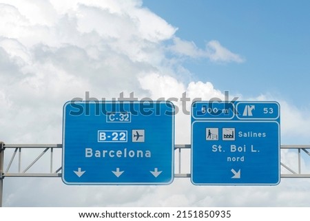 highway exit sign with airport sign and barcelona city
