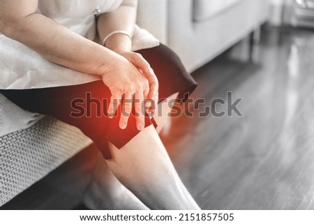 Old people stay alone at home has injury concept. Asian elderly woman has knee osteoarthritis pain. Royalty-Free Stock Photo #2151857505