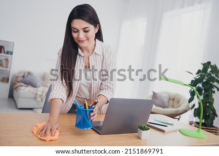 Portrait of attractive focused long-haired woman manager student working remotely polishing desktop at home indoors