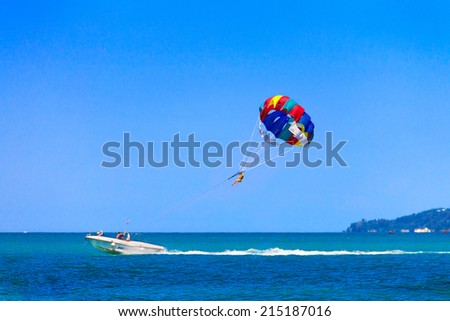 Parasailing is a popular pastime in many resorts around the world. The active form of relaxation. Focus on a parachute. Royalty-Free Stock Photo #215187016