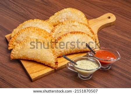 fried pastry, fogazza, meat pastry, cheese pastry, served with mayonnaise and chili sauce, timico Brazilian bar snack. Royalty-Free Stock Photo #2151870507