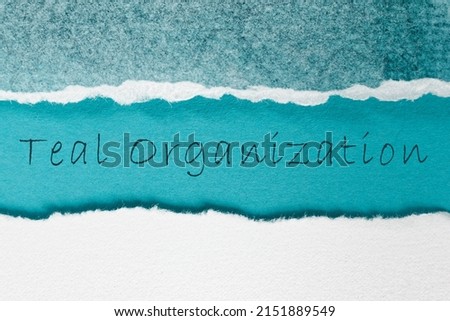 Teal Organization words on turquoise color paper. Self-management in organizations concept.  Royalty-Free Stock Photo #2151889549