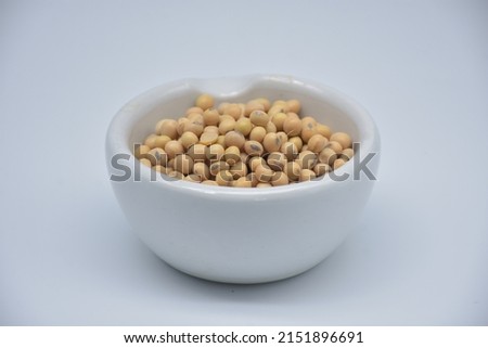 close up picture of dried soy beans in white ceramic cup