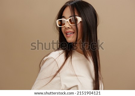 beautiful woman in a beige T-shirt with glasses posing clothing fashion isolated background Royalty-Free Stock Photo #2151904121