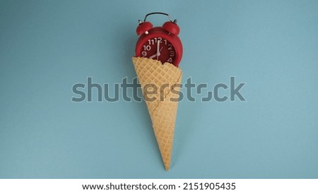 Red alarm clock in a sugar cone.