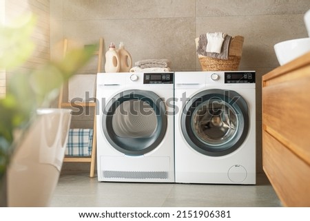 Interior of a real laundry room with a washing machine at home Royalty-Free Stock Photo #2151906381