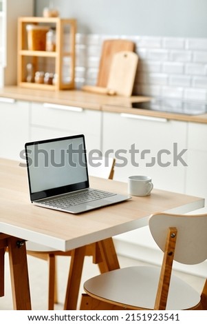 Vertical background image of minimal home workplace with laptop on kitchen table, copy space