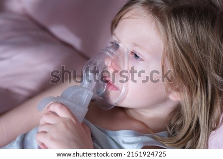 Sick little child in medical oxygen mask lying in bed Royalty-Free Stock Photo #2151924725