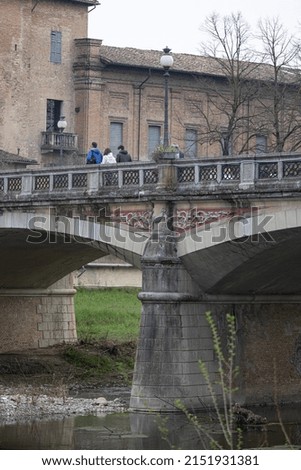 People Walking on the Bridge in the center of Parma on a Spring Day, Italy.