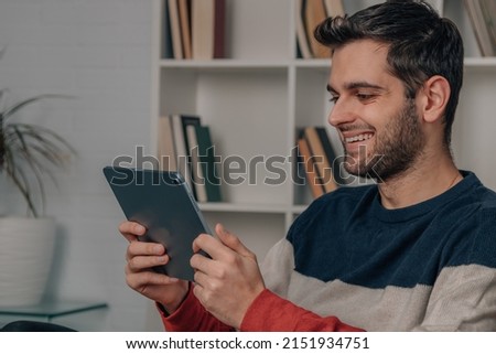 young man at home with digital tablet or laptop