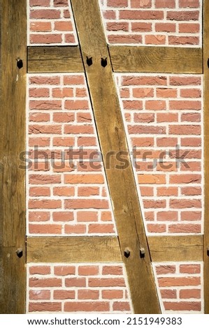 Fachwerk. Beautiful wall made of red bricks and wooden beams. Abstract background. 