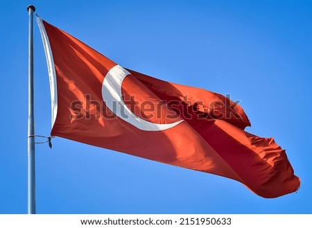 Turkish flag close-up against a blue sky background