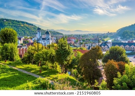 Magnificent view from fortified old city of Sighisoara down to lower city and Tarnava Mare river valley during sunrise. Sighisoara, Transylvania region, Romania. UNESCO world heritage site Royalty-Free Stock Photo #2151960805