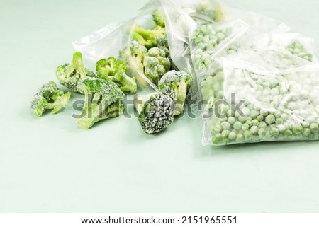 Frozen vegetables, close-up. Green peas and broccoli in transparent bags. proper defrosting of vegetables. Royalty-Free Stock Photo #2151965551