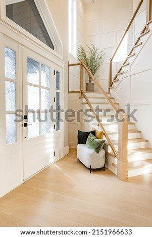 warm and welcoming foyer with colorful glass doors hardwood floors and staircase

 Royalty-Free Stock Photo #2151966633