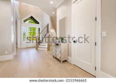 warm and welcoming foyer with colorful glass doors hardwood floors and staircase

 Royalty-Free Stock Photo #2151966663