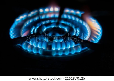 Symbol of pacifism. The flame of a gas burner in the dark. The concept of natural gas supply from Russia to Europe. Isolated black background. Pacific. Close up.